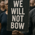 Protest sign stating 'We Will Not Bow'.